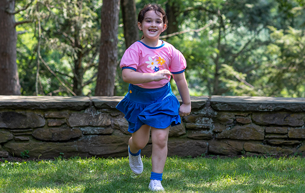 high school girl scout with tote bag outside at park or camp