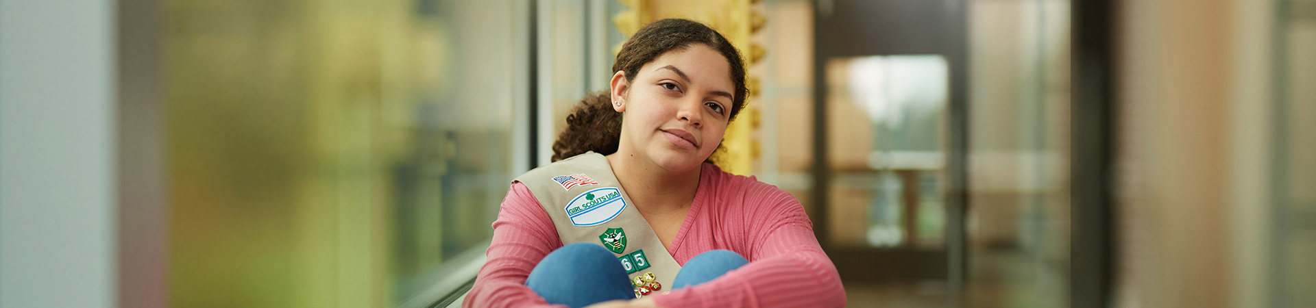 girl scout ambassador high school girl in school wearing sash with highest awards pins 