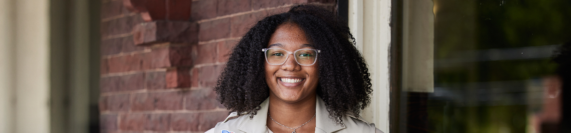  high school gold award girl scout with natural hair wearing ambassador vest 